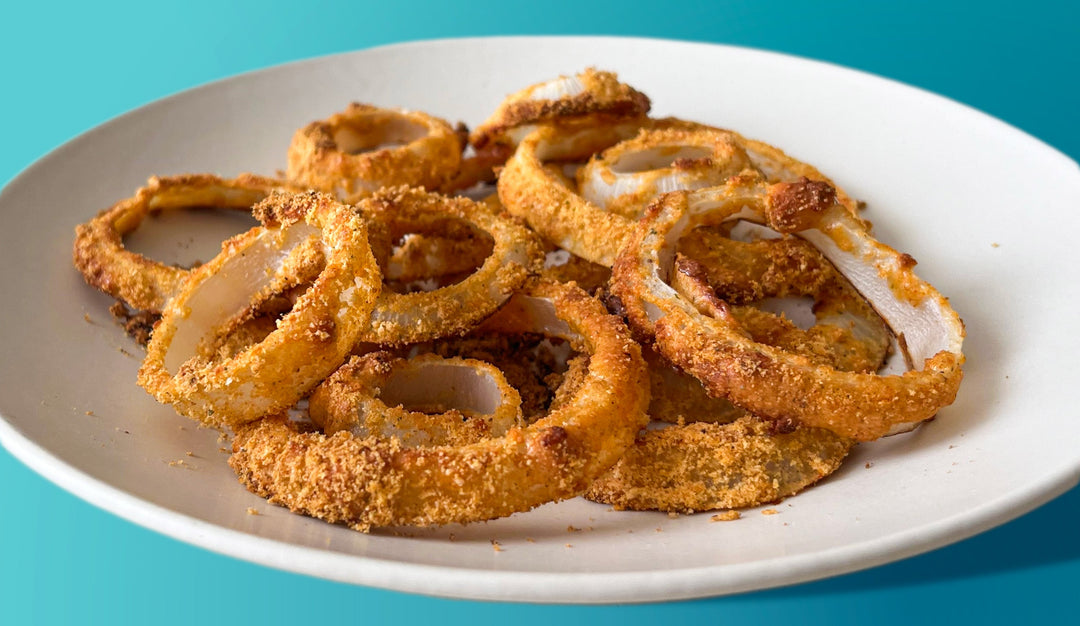 High protein onion rings on a white serving plate.