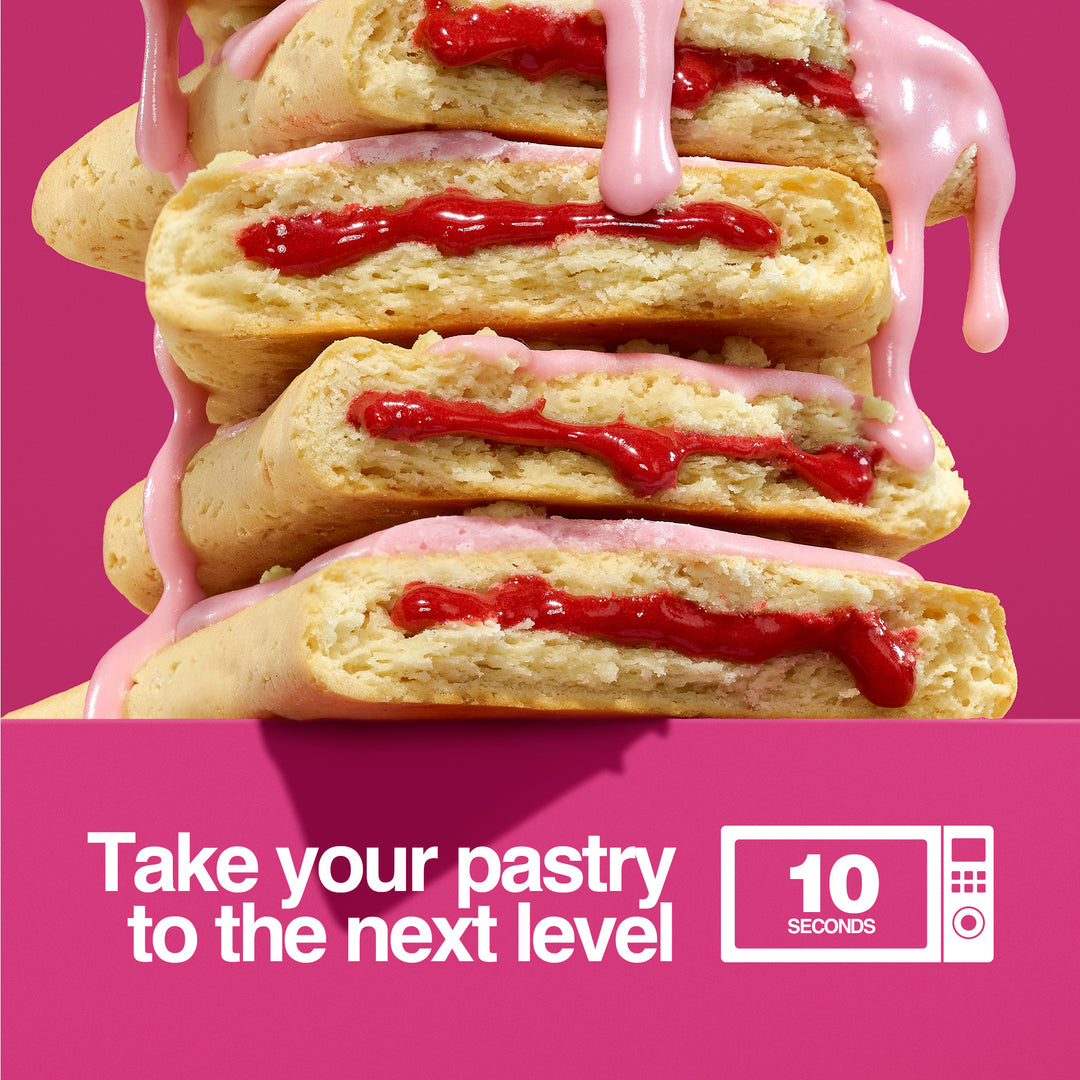 Stacked Cherry Crumble protein pastries with melted cherry filling and pink icing dripping. Text: 'Take your pastry to the next level' with microwave icon.